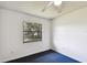 A bright bedroom featuring carpet and a window overlooking the lush backyard at 5455 Pinetrail Way, Orlando, FL 32822