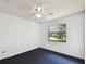 A bright bedroom featuring carpet and a window overlooking the lush backyard at 5455 Pinetrail Way, Orlando, FL 32822