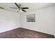 Well-lit bedroom with dark wood floors and a ceiling fan at 5455 Pinetrail Way, Orlando, FL 32822