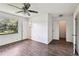 Comfortable bedroom featuring new wood flooring and natural lighting at 5455 Pinetrail Way, Orlando, FL 32822