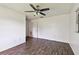 This bedroom boasts new wood floors and a modern ceiling fan at 5455 Pinetrail Way, Orlando, FL 32822