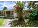 Exterior of property featuring mature landscaping and walkway to entry at 5455 Pinetrail Way, Orlando, FL 32822