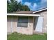 Home exterior featuring a window with blinds and a white door, providing a glimpse of the building's facade at 5455 Pinetrail Way, Orlando, FL 32822