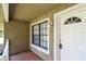Inviting covered front porch with a view of the front door and windows at 5455 Pinetrail Way, Orlando, FL 32822