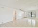 Living room featuring tile flooring, ceiling light, and a large window at 5455 Pinetrail Way, Orlando, FL 32822