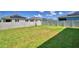 Spacious backyard with lush green grass, offering ample room for outdoor activities and relaxation at 2005 Carnostie Rd, Winter Haven, FL 33884