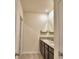 Bathroom featuring a granite countertop and dark brown cabinetry, offering style and functionality at 2005 Carnostie Rd, Winter Haven, FL 33884