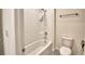 Bright bathroom showcasing a tub and shower combination, along with a toilet and modern fixtures at 2005 Carnostie Rd, Winter Haven, FL 33884