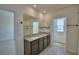 Bright bathroom with dual sinks, large mirror, and tile flooring offers a modern and functional space for your needs at 2005 Carnostie Rd, Winter Haven, FL 33884