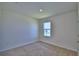 Cozy bedroom with carpet, window, and trim at 2005 Carnostie Rd, Winter Haven, FL 33884