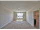 Spacious bedroom with neutral carpet, natural light and an ensuite bathroom provides relaxation and convenience at 2005 Carnostie Rd, Winter Haven, FL 33884