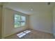 Bright, carpeted bedroom featuring a large window, offering natural light and outdoor views at 2005 Carnostie Rd, Winter Haven, FL 33884