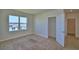 Carpeted bedroom with a window overlooking the neighborhood, and closet at 2005 Carnostie Rd, Winter Haven, FL 33884