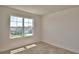 Bedroom with a large window providing natural light and a view of the surrounding neighborhood at 2005 Carnostie Rd, Winter Haven, FL 33884