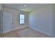 Well-lit bedroom featuring plush carpeting and a window for natural light at 2005 Carnostie Rd, Winter Haven, FL 33884