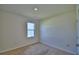 Bedroom featuring carpet, window, and neutral walls at 2005 Carnostie Rd, Winter Haven, FL 33884