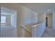 Upstairs hallway with neutral carpet leading to bedrooms and other living spaces at 2005 Carnostie Rd, Winter Haven, FL 33884