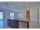 Granite-topped kitchen island featuring stainless steel dishwasher and cabinetry, nearby staircase at 2005 Carnostie Rd, Winter Haven, FL 33884