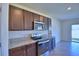 Modern kitchen featuring granite countertops, stainless steel appliances, and dark wood cabinetry at 2005 Carnostie Rd, Winter Haven, FL 33884