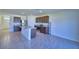 Open-concept kitchen with stainless steel appliances, granite countertops, and tile flooring at 2005 Carnostie Rd, Winter Haven, FL 33884