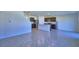 The open-concept space includes a kitchen with stainless steel appliances and breakfast bar at 2005 Carnostie Rd, Winter Haven, FL 33884