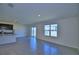 Open-concept living area with modern tile, sliding glass doors, and a view into the kitchen at 2005 Carnostie Rd, Winter Haven, FL 33884