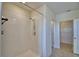 Step-in shower features a bright white tile surround, offering a clean and modern look with a refreshing experience at 2005 Carnostie Rd, Winter Haven, FL 33884