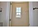 Organized walk-in closet with window offers ample storage with shelving to keep your belongings neat and accessible at 2005 Carnostie Rd, Winter Haven, FL 33884