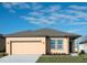 Charming single-story home featuring a neutral color scheme, a two-car garage and a well-manicured lawn at 3079 Daffodil Dr, Lake Hamilton, FL 33851