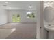 Bright room with double doors leading to the yard and a view of the pedestal sink in the half bathroom at 3431 Vesara Dr, Davenport, FL 33837
