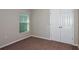 Bedroom with a window with blinds and double-door closet with neutral walls and carpeting at 762 Ambleside Dr, Haines City, FL 33844