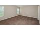 Comfortable bedroom with plush carpeting, neutral walls, and ample natural light from windows at 762 Ambleside Dr, Haines City, FL 33844