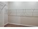 Walk-in closet featuring installed shelving with neutral walls and carpeting at 762 Ambleside Dr, Haines City, FL 33844