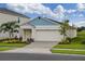Charming single-Gathering home with a two-car garage, green lawn, and well-maintained landscaping at 762 Ambleside Dr, Haines City, FL 33844