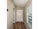 Hallway with wood-look flooring with neutral walls, a door, and a window with blinds at 762 Ambleside Dr, Haines City, FL 33844