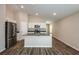 Open-concept kitchen layout with an island sink, stainless steel appliances, and a seamless connection to living area at 762 Ambleside Dr, Haines City, FL 33844