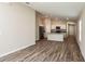 Bright open floor plan showcasing the living room with wood-look flooring and neutral paint at 762 Ambleside Dr, Haines City, FL 33844