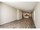 Open concept living space showcasing wood-look flooring and a seamless flow into the kitchen area at 762 Ambleside Dr, Haines City, FL 33844
