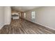 Spacious living area featuring wood-look floors and large windows for natural light at 762 Ambleside Dr, Haines City, FL 33844