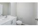 Modern bathroom featuring a sleek white vanity and a large, well-lit mirror at 3730 King Hill Dr, Haines City, FL 33844