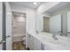 Bathroom featuring double sink vanity with modern fixtures, shower, and wood-look flooring at 3730 King Hill Dr, Haines City, FL 33844