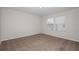Bright, airy bedroom with plush carpeting and two windows providing natural light at 3730 King Hill Dr, Haines City, FL 33844