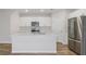 Modern kitchen featuring white cabinets, stainless steel appliances, and a center island at 3730 King Hill Dr, Haines City, FL 33844