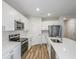 Bright kitchen featuring white cabinets, stainless steel appliances, and hard surface countertops at 3730 King Hill Dr, Haines City, FL 33844