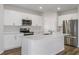 Modern kitchen featuring white cabinets, stainless steel appliances, and a center island at 3730 King Hill Dr, Haines City, FL 33844