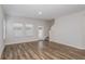 Spacious living room with hardwood floors, large windows, and staircase at 3730 King Hill Dr, Haines City, FL 33844