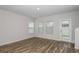 Bright room with wood-look floors, white walls, and large windows at 3730 King Hill Dr, Haines City, FL 33844