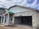 Home under construction features a covered front porch and garage with concrete walls and a partially completed roof at 5728 Haystack Drive, St Cloud, FL 34771