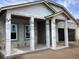Covered porch area of a new home under construction, showcasing support columns and concrete slab at 5728 Haystack Drive, St Cloud, FL 34771
