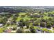 Expansive aerial view of the community showcasing the lush golf course, trees, and neighborhood homes at 6642 Parson Brown Dr, Orlando, FL 32819